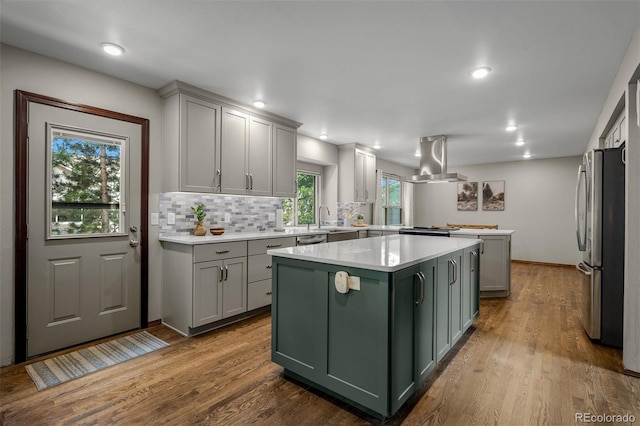 6285 Moccasin Pass Ct, Colorado Springs, CO 80919 - kitchen featuring green cabinets, stainless steel appliances, a kitchen island, light countertops, and recessed lighting