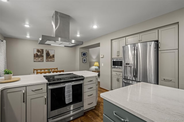 6285 Moccasin Pass Ct, Colorado Springs, CO 80919 - kitchen featuring island exhaust hood, stainless steel appliances, gray cabinets, dark wood finished floors, and recessed lighting