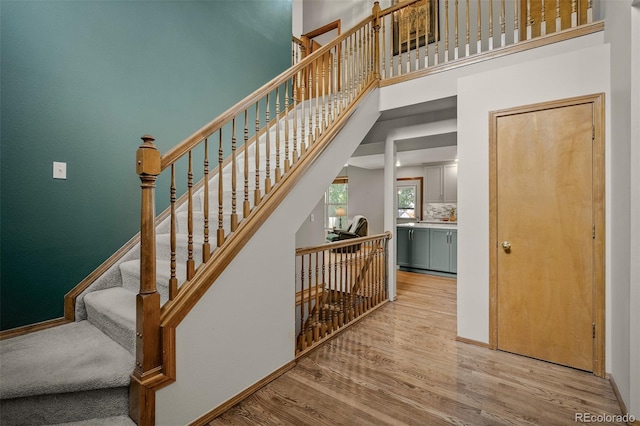 6285 Moccasin Pass Ct, Colorado Springs, CO 80919 - stairs with wood finished floors and a high ceiling