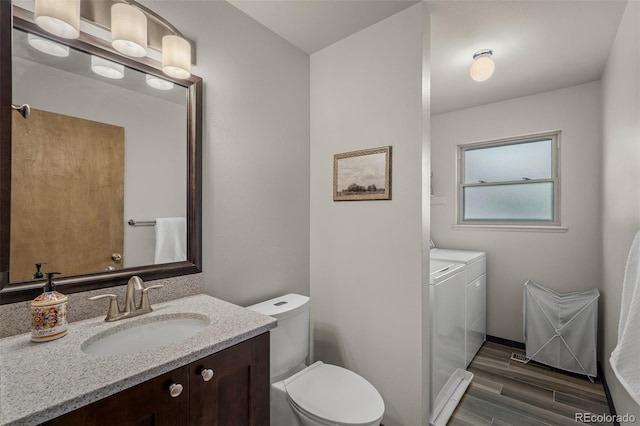 6285 Moccasin Pass Ct, Colorado Springs, CO 80919 - bathroom featuring separate washer and dryer, wood finished floors, and vanity