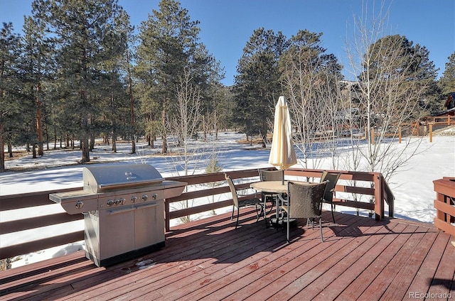 snow covered deck featuring a grill