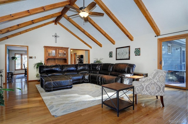 living room featuring hardwood / wood-style floors, beam ceiling, and high vaulted ceiling