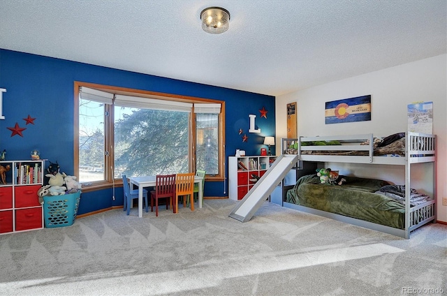 carpeted bedroom featuring a textured ceiling