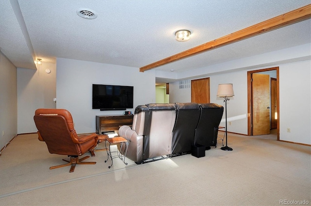 living room featuring beamed ceiling, light colored carpet, and a textured ceiling