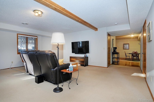 carpeted living room with beamed ceiling and a textured ceiling