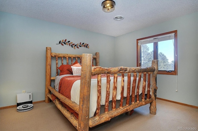 bedroom with carpet and a textured ceiling