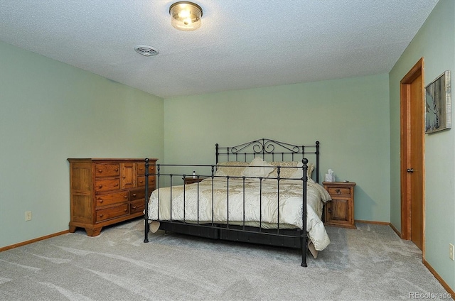 carpeted bedroom with a textured ceiling