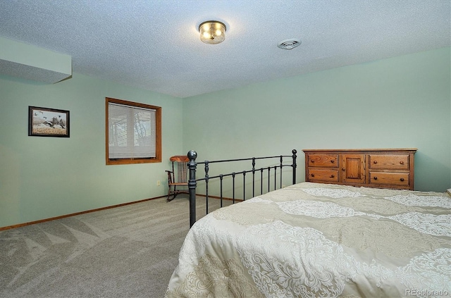 carpeted bedroom featuring a textured ceiling