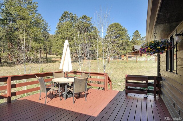 18360 Trail W Dr, Buena Vista, CO 81211 - deck with outdoor dining area and a lawn