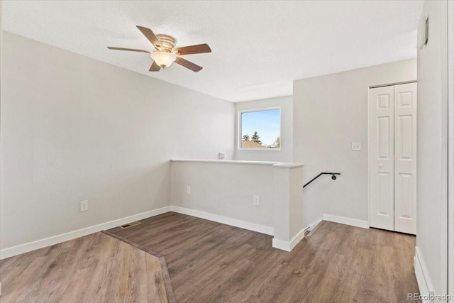 1488 S Andes Way, Aurora, CO 80017 - empty room featuring wood finished floors, a ceiling fan, and baseboards