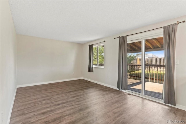 1488 S Andes Way, Aurora, CO 80017 - spare room with wood finished floors, baseboards, and a textured ceiling