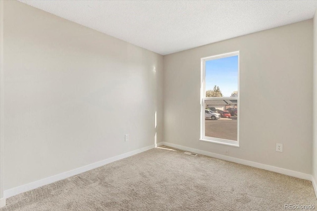 1488 S Andes Way, Aurora, CO 80017 - spare room featuring carpet floors, baseboards, and a textured ceiling