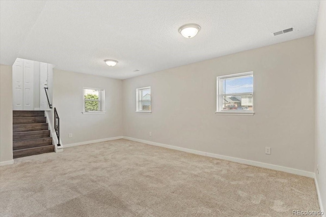 1488 S Andes Way, Aurora, CO 80017 - basement with carpet, baseboards, a textured ceiling, and stairway