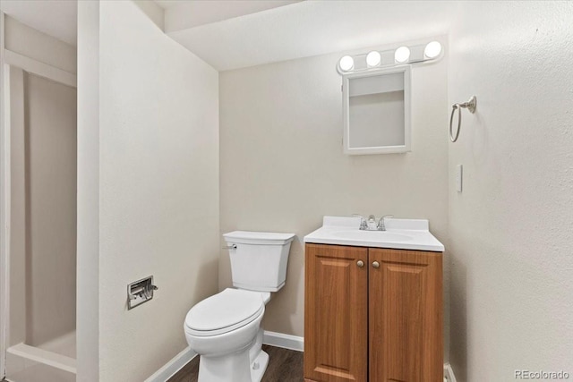 1488 S Andes Way, Aurora, CO 80017 - full bathroom featuring toilet, vanity, wood finished floors, baseboards, and a shower