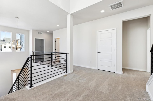 interior space with carpet flooring and a chandelier