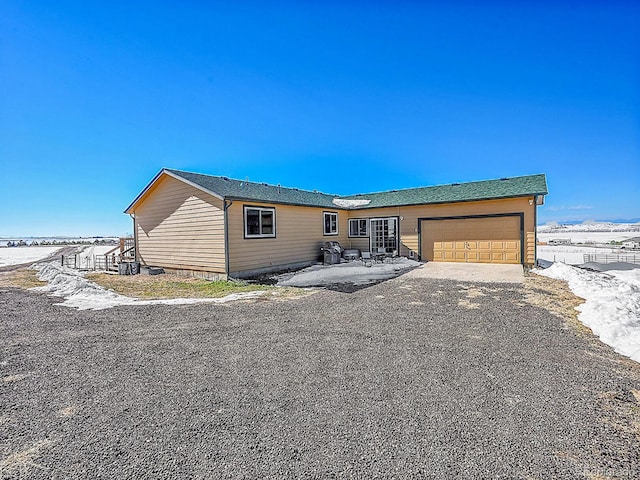 view of front of property with a patio area and a garage