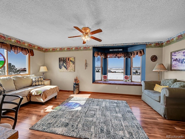 living room featuring hardwood / wood-style floors, a textured ceiling, and plenty of natural light