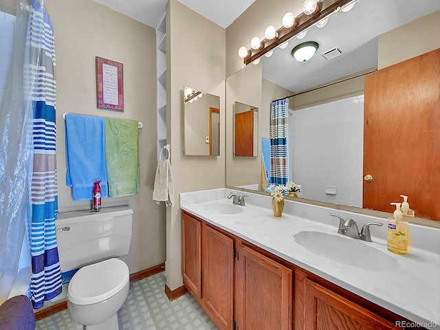 bathroom featuring walk in shower, vanity, and toilet