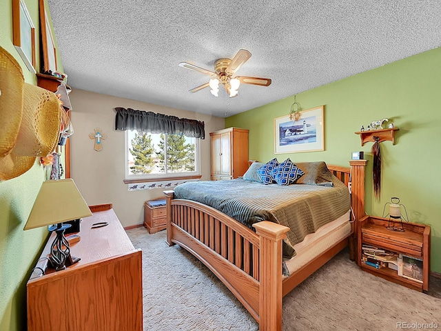 carpeted bedroom with ceiling fan and a textured ceiling