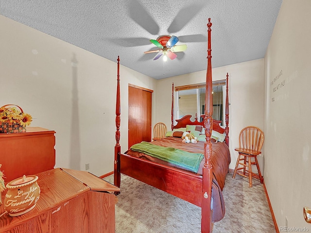 carpeted bedroom with a textured ceiling and ceiling fan