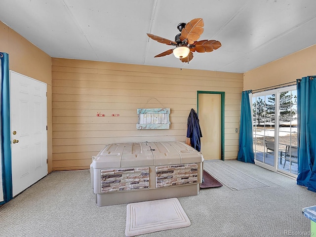 unfurnished bedroom with access to exterior, ceiling fan, and carpet