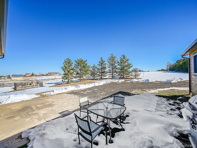 view of yard layered in snow