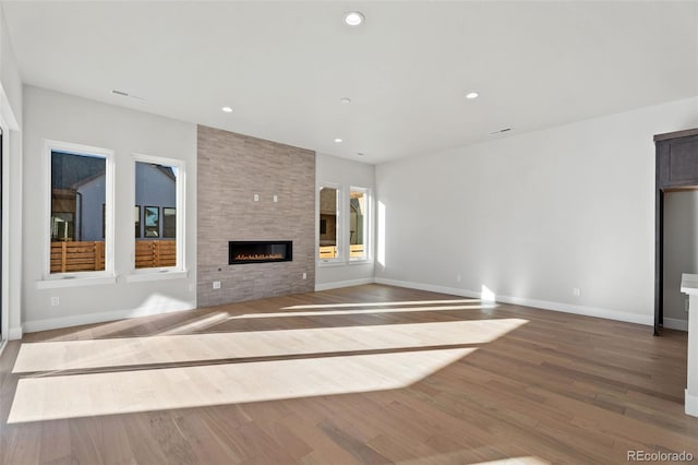 unfurnished living room with hardwood / wood-style floors and a fireplace