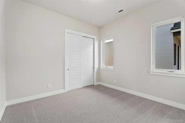 unfurnished bedroom featuring a closet and carpet flooring