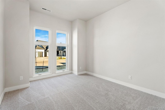 spare room featuring light colored carpet