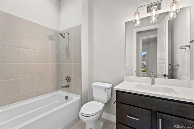 full bathroom with toilet, tile patterned floors, tiled shower / bath, and vanity