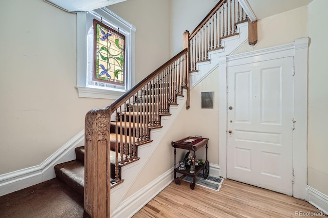 stairway featuring baseboards and wood finished floors