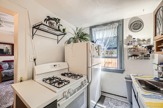 kitchen featuring a ceiling fan, a textured ceiling, and white gas range