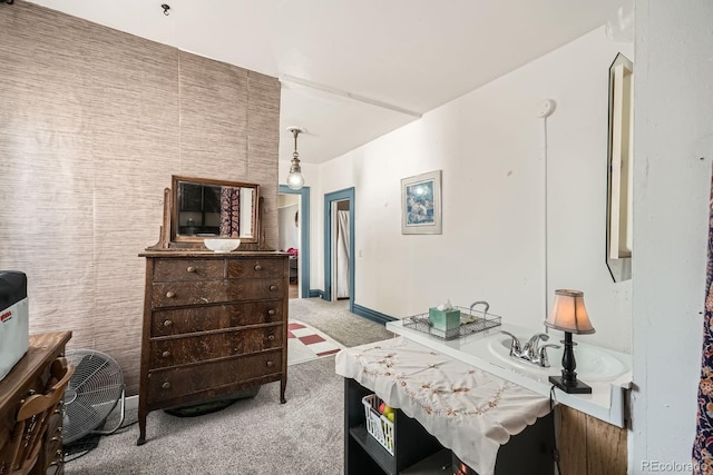 bedroom with baseboards and light carpet