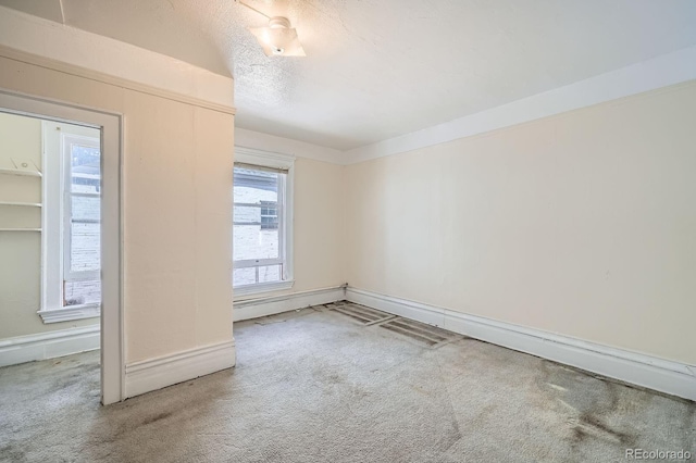 unfurnished room featuring baseboards and carpet flooring