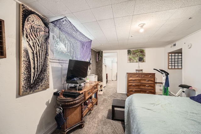 carpeted bedroom featuring visible vents