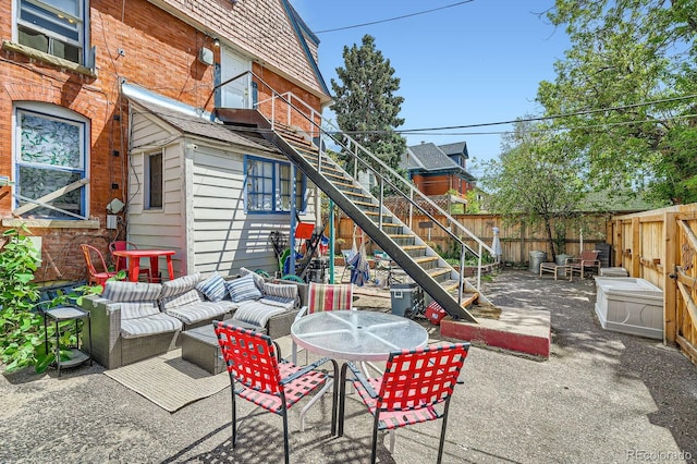 view of patio with stairs, a fenced backyard, and an outdoor hangout area