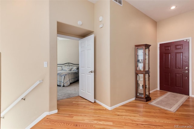 foyer featuring baseboards, recessed lighting, light wood finished floors, and visible vents