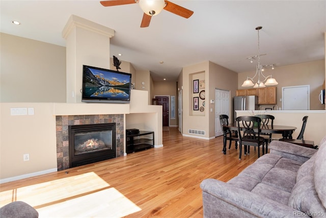 living area featuring visible vents, a fireplace, ceiling fan, recessed lighting, and light wood-style flooring
