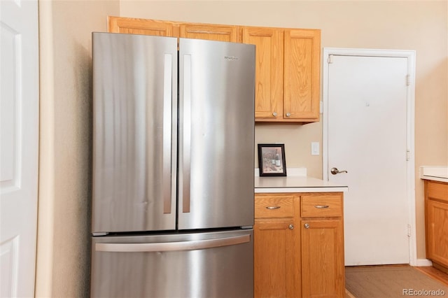 kitchen featuring freestanding refrigerator and light countertops