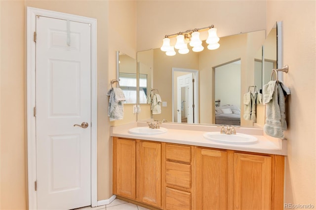 full bath with a sink, tile patterned flooring, double vanity, and connected bathroom