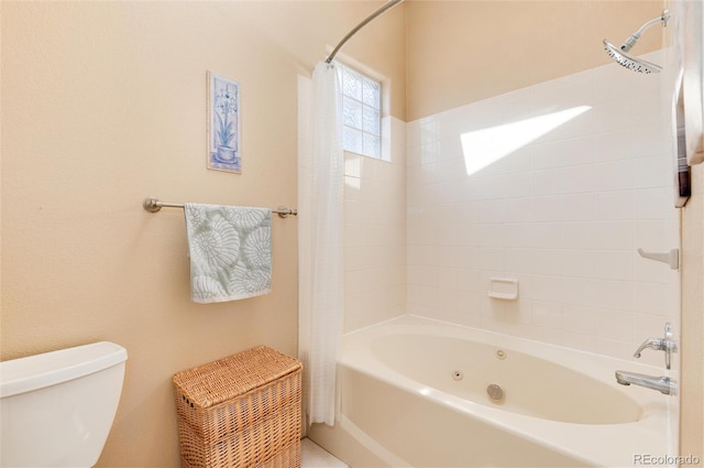 full bath with shower / bath combo with shower curtain and toilet