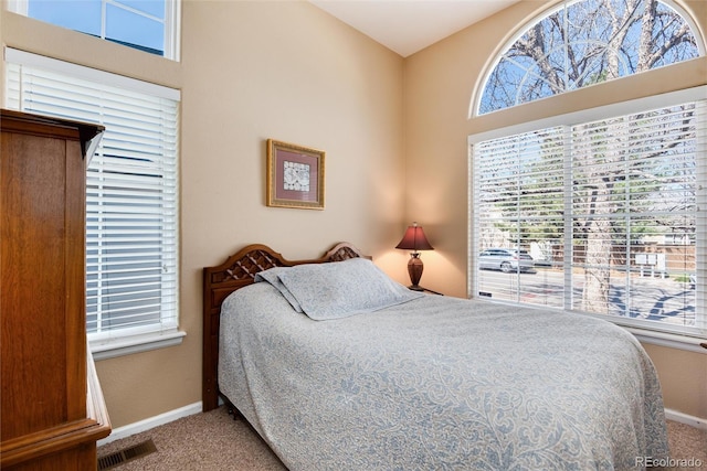 carpeted bedroom with baseboards and visible vents