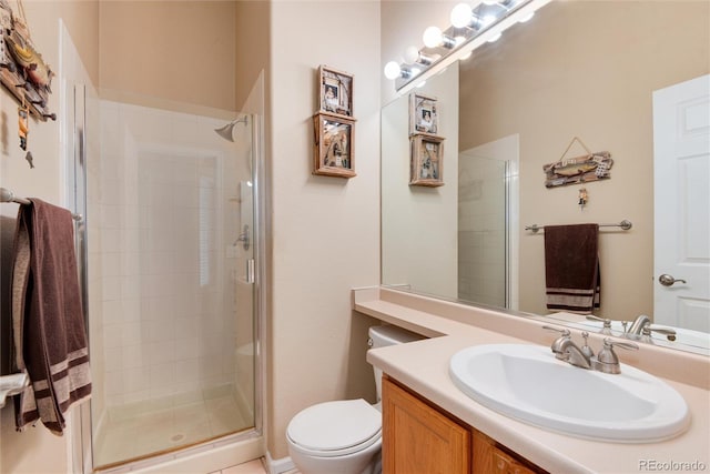 full bathroom with vanity, a shower stall, and toilet