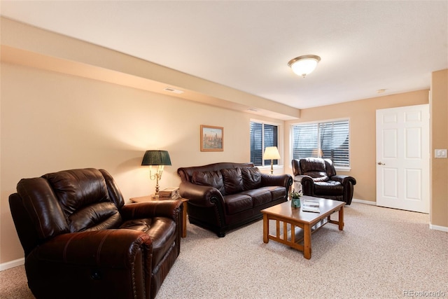 living room with baseboards, visible vents, and light carpet
