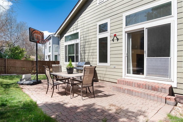 view of patio / terrace with fence, outdoor dining area, and entry steps