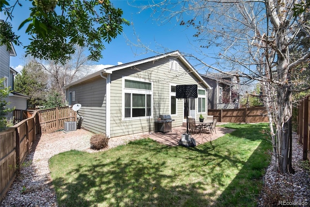 back of house with a yard, a patio, and a fenced backyard