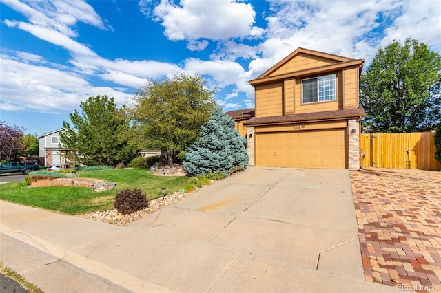 view of front of home featuring a garage and a front lawn