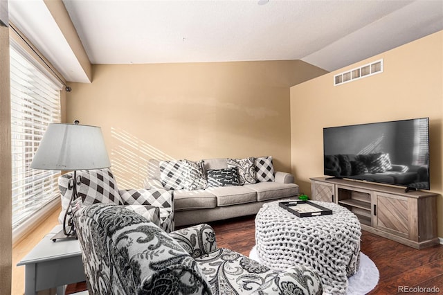 living room featuring lofted ceiling and dark hardwood / wood-style flooring