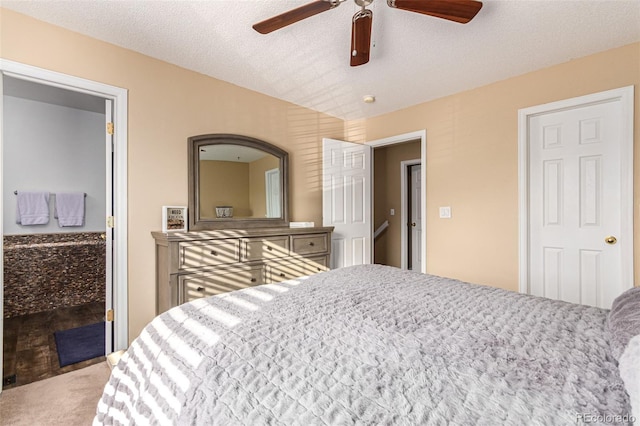 bedroom with a textured ceiling, ceiling fan, and carpet