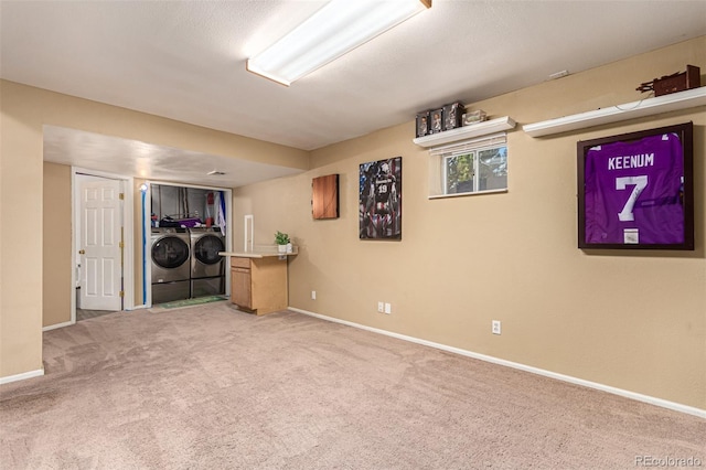 basement with washer and dryer and carpet